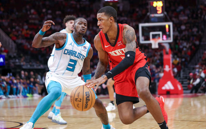 Rockets forward Jabari Smith Jr. attempts to drive with the ball around Charlotte Hornets guard Terry Rozier during the fourth quarter at Toyota Center.